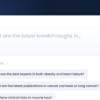 Hero banner showing a white rounded card on a dark blue gradient background, with red, yellow, and green window buttons and the heading 'What are the latest breakthroughs in…' plus a blue rounded button with an upward arrow on the right.