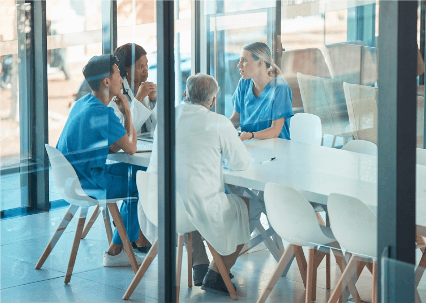 Medical professionals in discussion with city skyline background