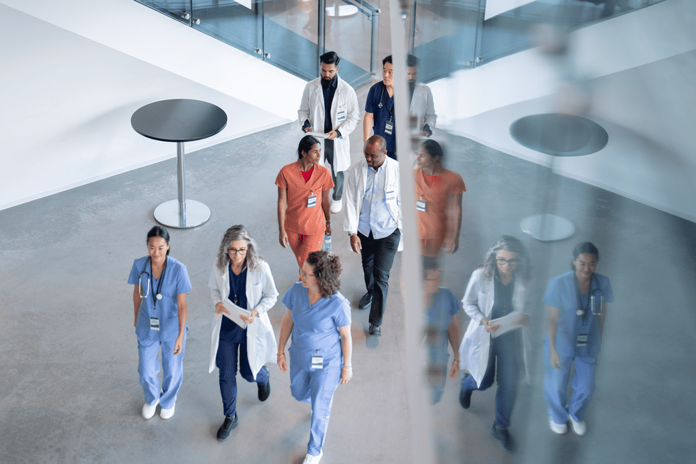 Medical professionals in discussion with city skyline background