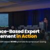 Conference room with a presenter at a podium on stage; audience watches as a slide deck with charts is projected on the left; large headline reads 'Evidence-Based Expert Engagement in Action'.